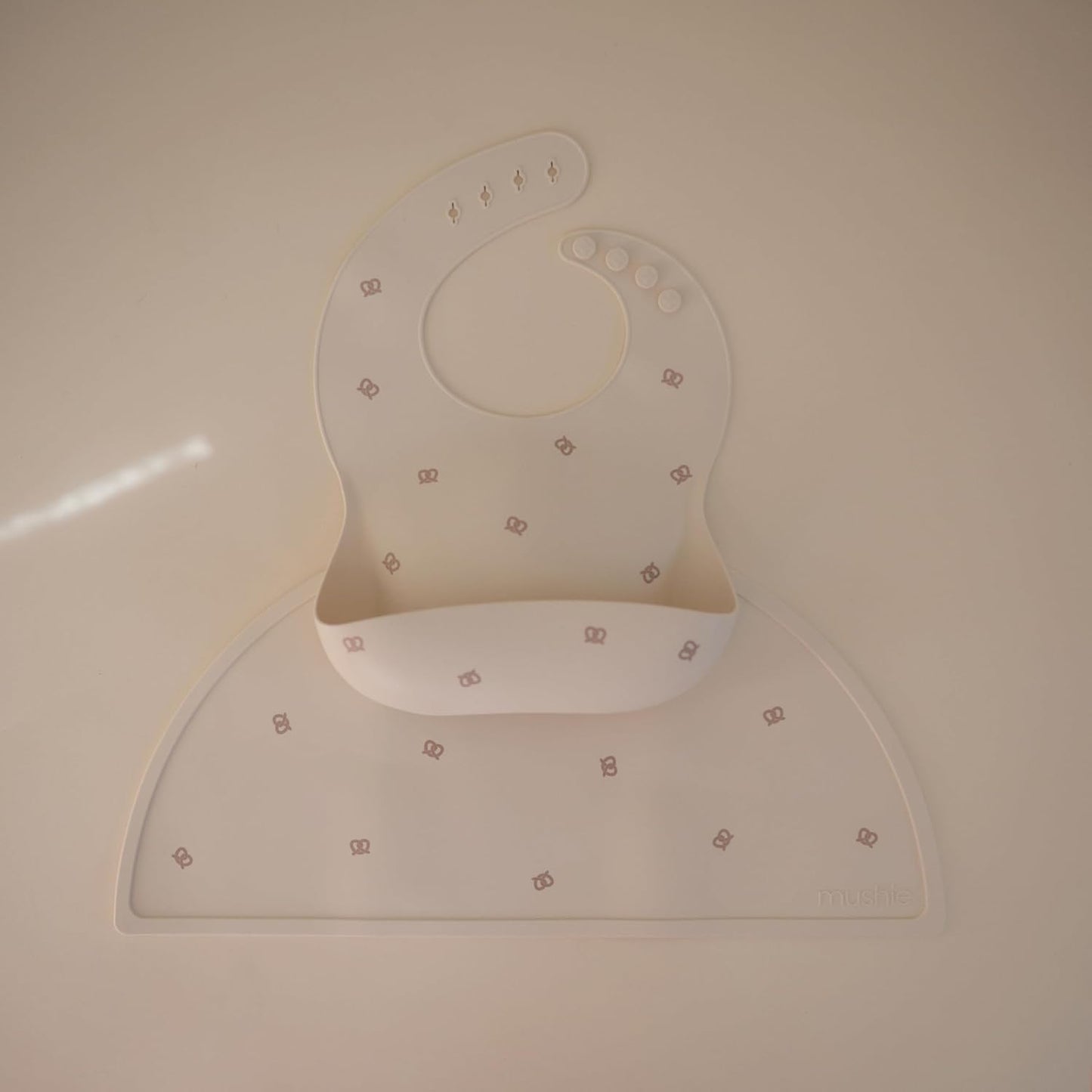 mushie Silicone Baby Bib | Adjustable Fit Waterproof Bibs (Pretzel)